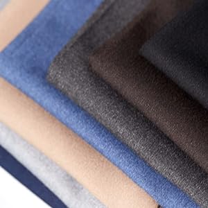 Pile of fabrics showing different colors: beige, indigo, charcoal, black