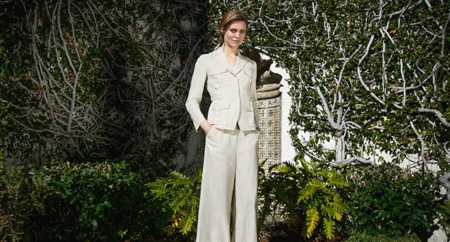 Model in a linen suit standing in a garden